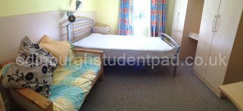 Bedroom 2 showing 2-seater settee, desk, wardrobes and double bed