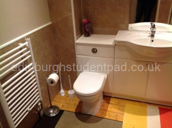 Bathroom 1, with large bath, shower over bath, basin and toilet.